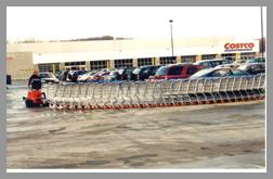 motorized pull cart mule moves trollys in the rain at Costco